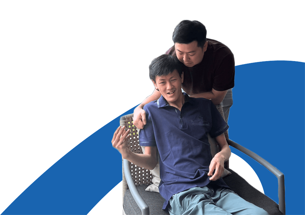 Two youth and caregiver smiling in chair together
