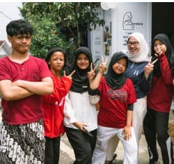 Children and mentors standing together smiling