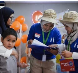 Volunteers and children participating in community activation event